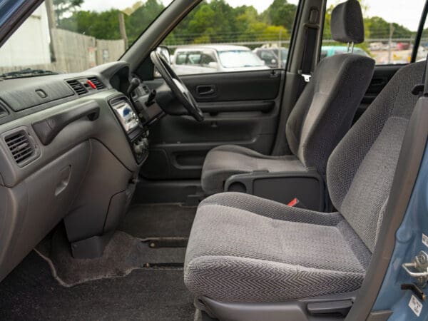 Grey car interior with front seats.