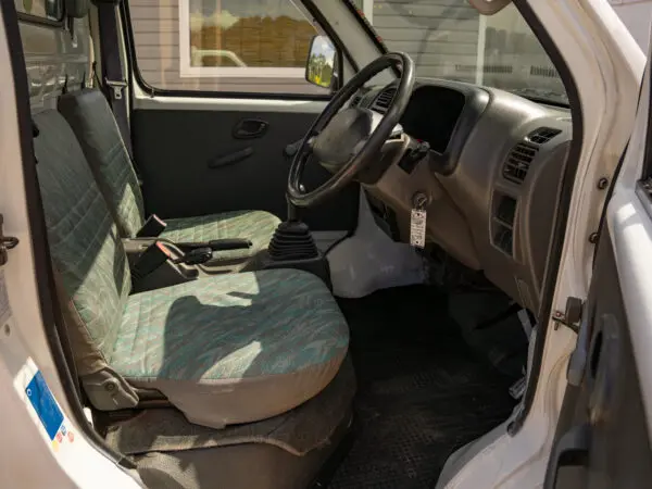 White van interior with two seats.