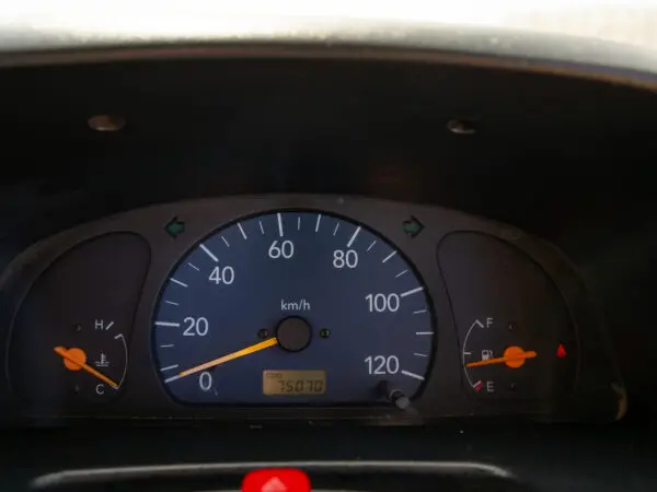 Car dashboard with speedometer and fuel gauge.