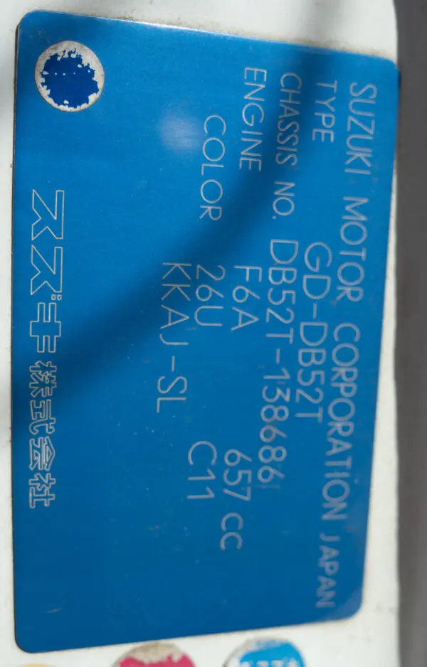 Suzuki car information sticker with details.