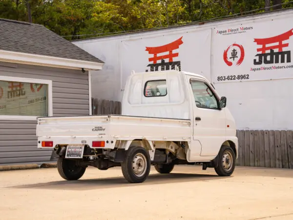 White Suzuki Carry pickup truck.