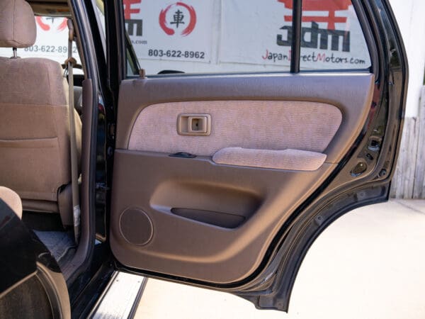 Black SUV car door open, interior view.