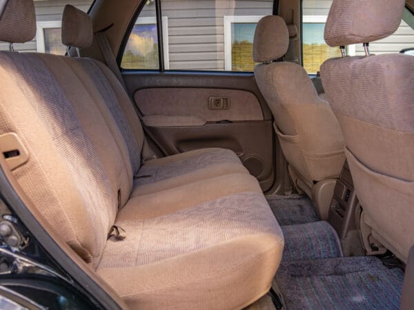 Tan fabric seats in SUV interior.