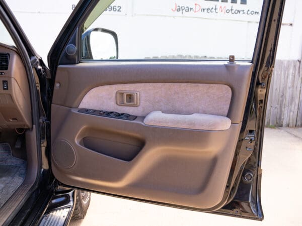 Black car door interior with brown trim.