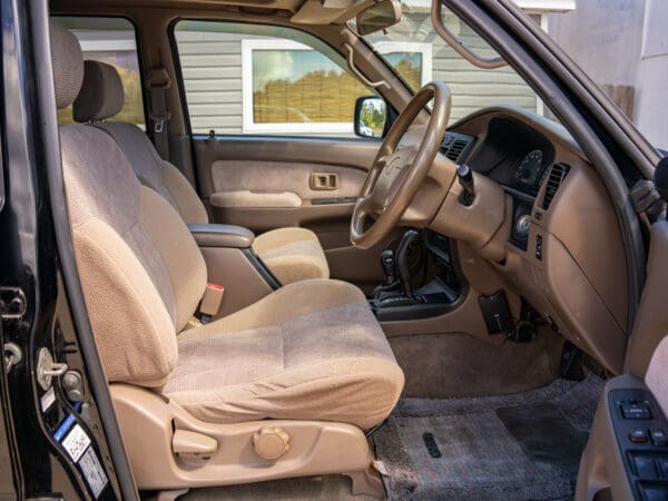 Black SUV interior with tan seats.