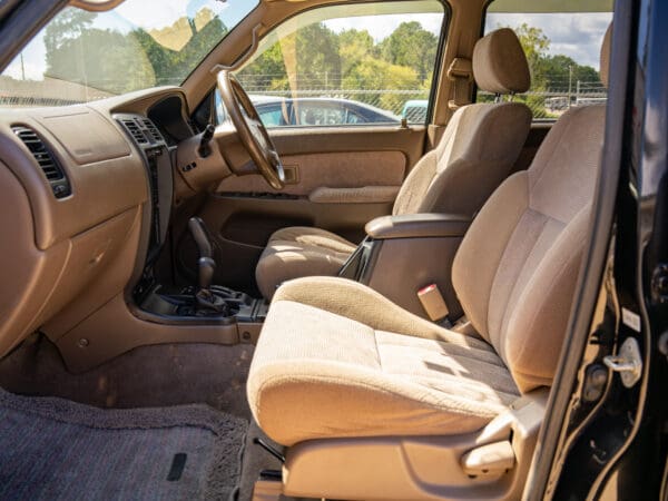 Beige interior of a black SUV.