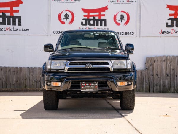 Black Toyota Land Cruiser SUV front view.