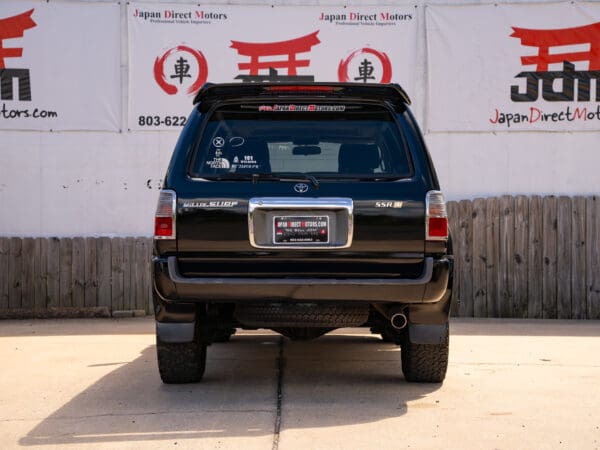 Black Toyota Land Cruiser SUV rear view.