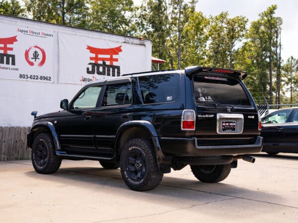 Black Toyota Land Cruiser rear view.