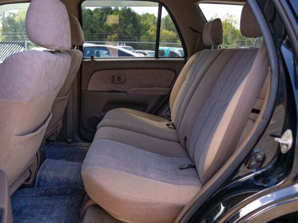 Black SUV with beige interior seats.