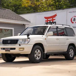 White Toyota Land Cruiser SUV parked outside.