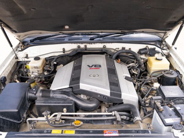 V8 engine under hood of a car.