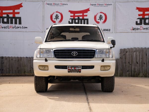 White Toyota Land Cruiser front view.