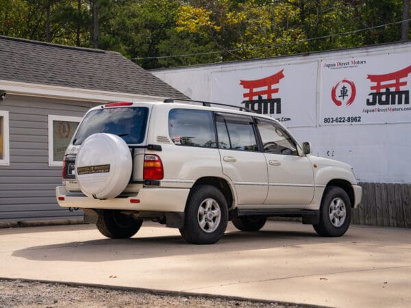 White Toyota Land Cruiser SUV parked.