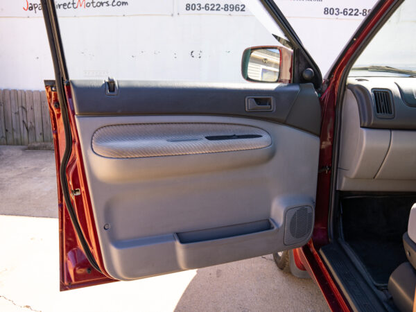 Red car's interior door panel detail.