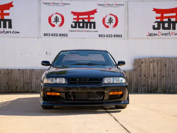 Black Nissan Skyline R33 front view.