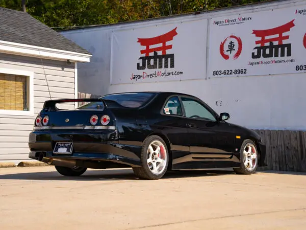 Black Nissan Skyline R33 rear view.