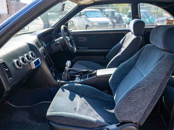 Black car interior with blue seats.