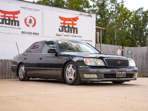 Black Lexus LS 400 parked outside.