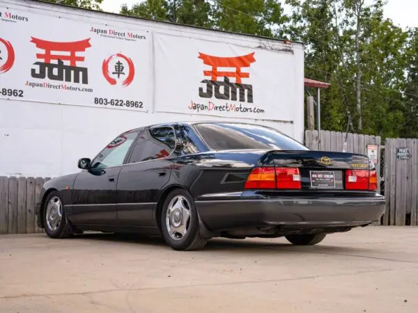 Black Lexus LS400 parked near a building.