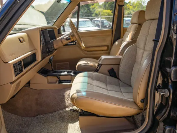 Tan interior of a black Jeep Cherokee.