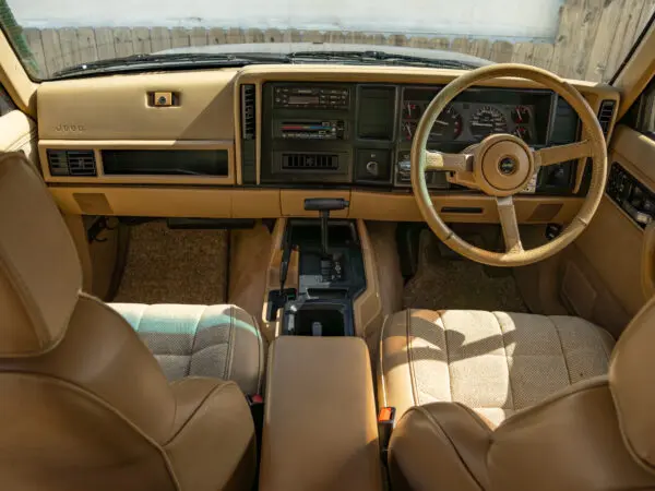 Tan Jeep Cherokee interior with steering wheel.