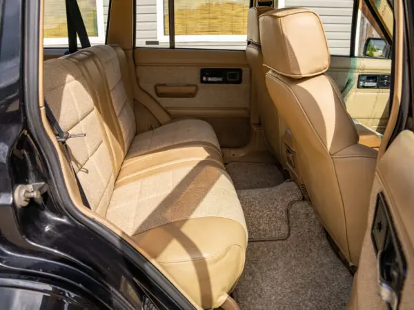 Tan leather interior of a black SUV.