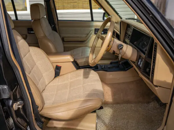 Tan interior of a black Jeep Cherokee.