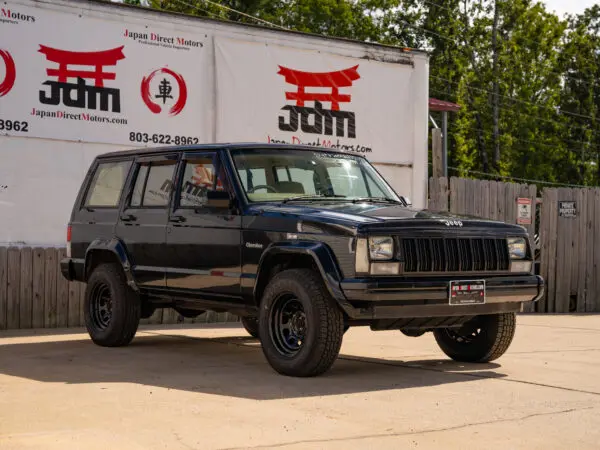 Black Jeep Cherokee SUV parked outdoors.