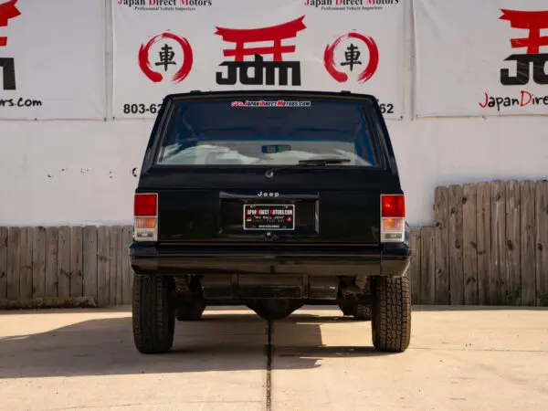 Black Jeep Cherokee rear view.