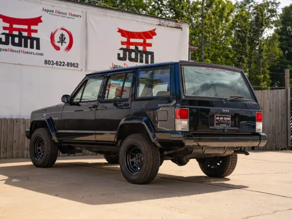 Black Jeep Cherokee rear view.