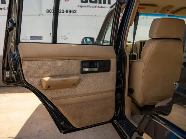 Black SUV interior with tan seats.