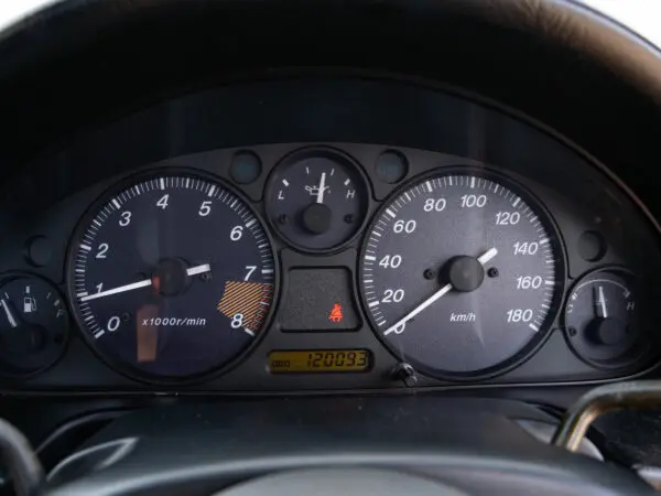 Car dashboard with speedometer and tachometer.