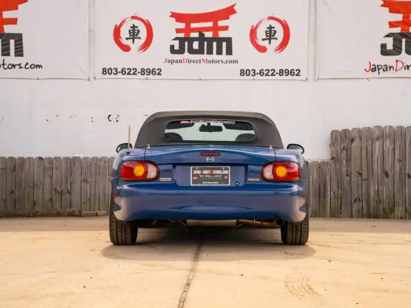 Blue Mazda MX-5 Miata rear view.