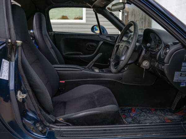 Blue convertible car interior with black seats.