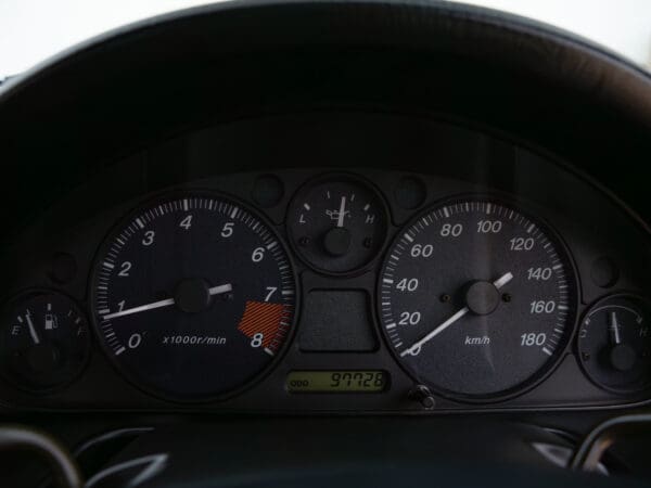 Car dashboard with speedometer and tachometer.