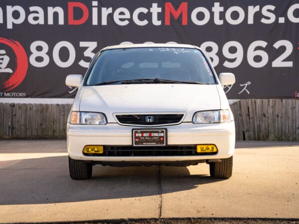 White Honda JDM minivan front view.