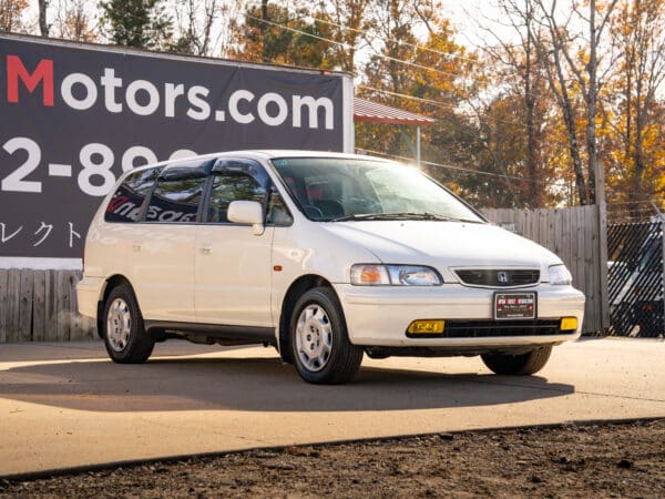 White Honda Odyssey minivan for sale.