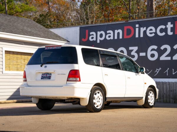 White Honda Odyssey minivan parked outdoors.