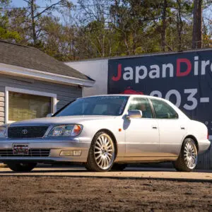 Silver Lexus LS400 parked outside.