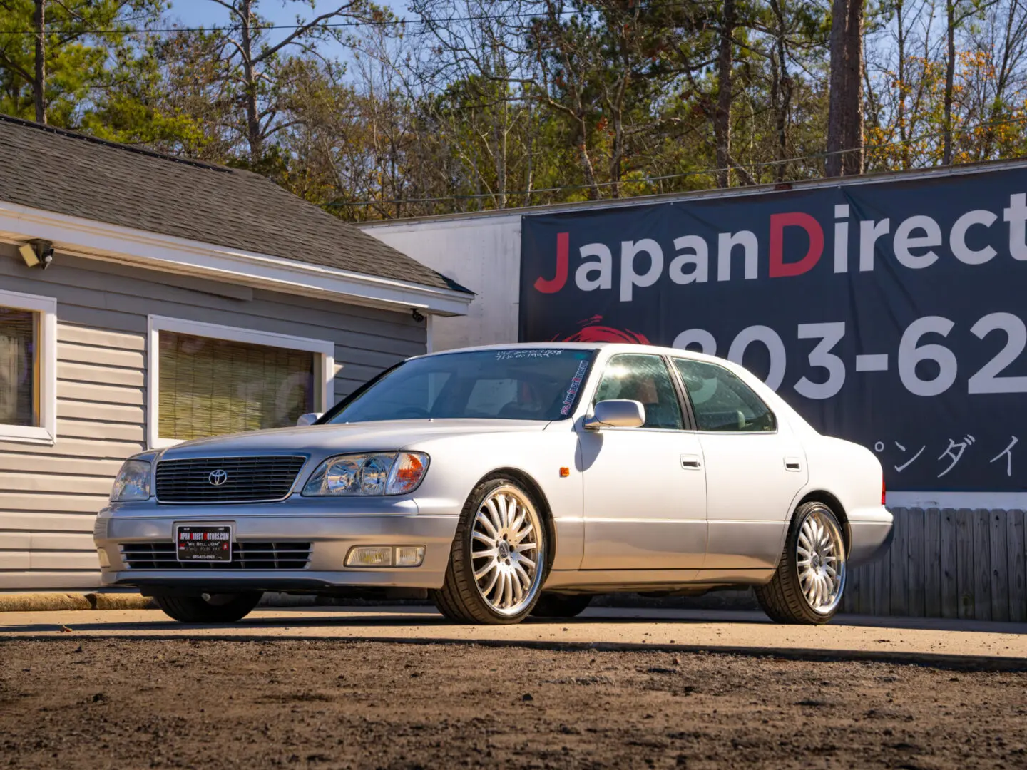 Silver Lexus LS400 parked outside.