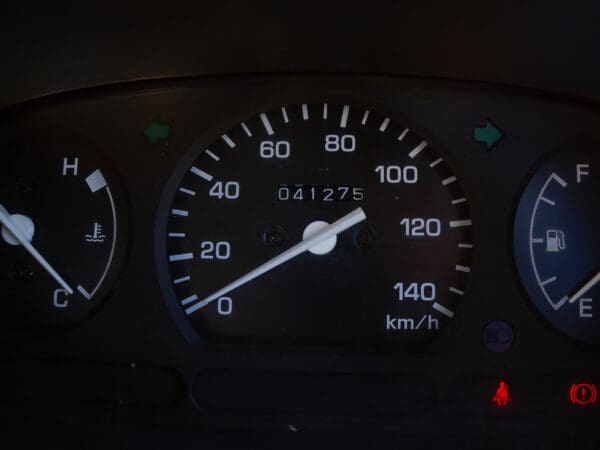 Car speedometer reads 75 km/h.