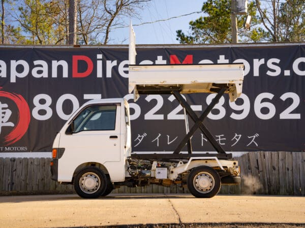 White mini dump truck, Japan Direct Motors.