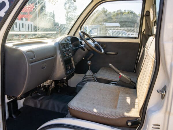 White mini-truck interior driver's seat.