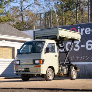 Light green Daihatsu Hijet mini truck.